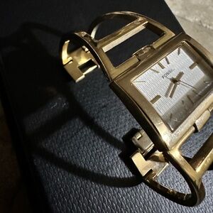 Fossil watch with open face gold bangle band